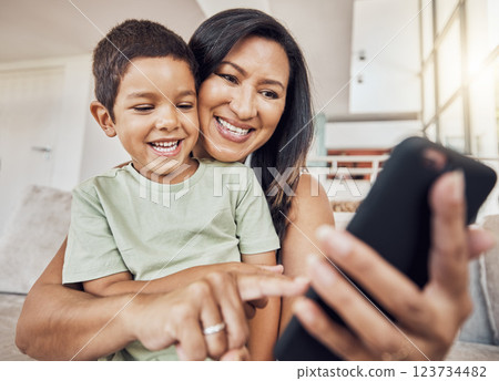 Selfie, mother and son phone in living room on sofa smile, together and happiness on smartphone. Happy mom, boy child or kid love to watch internet online film or video streaming mobile app at home 123734482