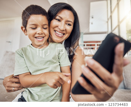 Happy mother and child with smartphone on sofa for games app, funny social media post or elearning website. Kid with mom on couch and cellphone education, video call or watch comedy video online 123734483
