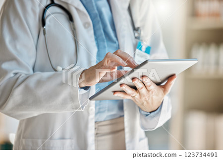 Doctor, office and tablet for research, email or communication. Medic, hospital and reading article, data or health magazine on web, while working with technology in healthcare center or clinic Doctor, office and tablet for research, email or communication. Medic, hospital and reading article, data or health magazine on web, while working with technology in healthcare center or clinic 123734491