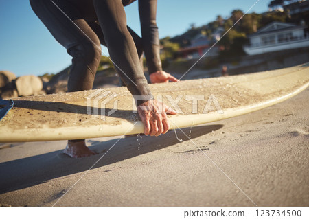 Hands, surfboard and beach surfer man on holiday, vacation or summer trip in Hawaii. Fitness, workout and male pick up board ready for surfing sports, fitness or exercise by sandy seashore outdoors. Hands, surfboard and beach surfer man on holiday, vacation or summer trip in Hawaii. Fitness, workout and male pick up board ready for surfing sports, fitness or exercise by sandy seashore outdoors. 123734500