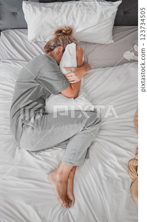 Sad, depression and woman with insomnia after divorce in the bed in house from above. Top view of depressed, tired and sick girl with stress, burnout or mental health problem in the bedroom Sad, depression and woman with insomnia after divorce in the bed in house from above. Top view of depressed, tired and sick girl with stress, burnout or mental health problem in the bedroom 123734505