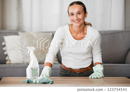 Woman cleaning home, table and living room with a chemical disinfectant soap spray bottle to clean house dirt. Adult housekeeping with a smile, family room is healthy and hygienic or germ free life 123734543