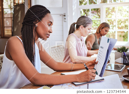 Black woman with business documents, writing at desk and women working together on audit report at startup. Diversity, teamwork and success, reading small business project proposal and taking notes. 123734544