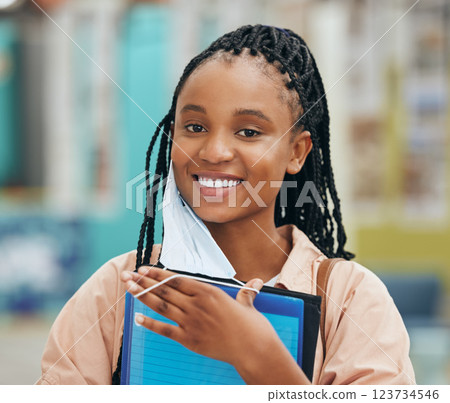 Smile, student and portrait of a black woman with a face mask holding a file at university in covid. Happy, excited and young African student with education books at college campus during pandemic. Smile, student and portrait of a black woman with a face mask holding a file at university in covid. Happy, excited and young African student with education books at college campus during pandemic. 123734546