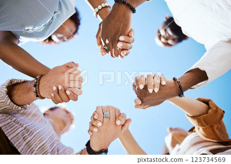 Diversity, support and people holding hands in trust and unity for community against sky background. Hand of diverse group in solidarity for united team building collaboration and teamwork success 123734569