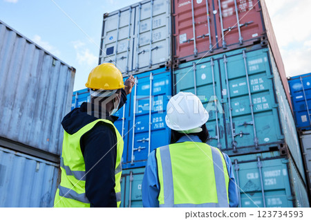 Logistics, shipping and manager planning container export with employee in an export delivery industry. Industrial workers working with stock or cargo transport at a international and global trade Logistics, shipping and manager planning container export with employee in an export delivery industry. Industrial workers working with stock or cargo transport at a international and global trade 123734593