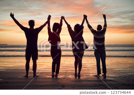 Beach, celebration and friends silhouette, sunset horizon and ocean for night, youth and adventure lifestyle. Freedom, group people shadow holding hands in dark sea with orange background mock up 123734644