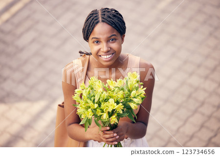 Flowers, gift and black woman with smile for bouquet for birthday or celebration in the street from above. Face of an African girl with a present of yellow lilies in the road and the city of France Flowers, gift and black woman with smile for bouquet for birthday or celebration in the street from above. Face of an African girl with a present of yellow lilies in the road and the city of France 123734656