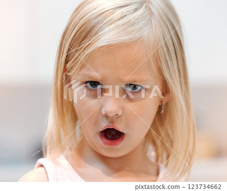 Angry, little girl and tantrum face portrait reaction to shock of rejection and disappointment. Unhappy, frustrated and moody female child with bad attitude and annoyed eyes closeup in Canada. 123734662