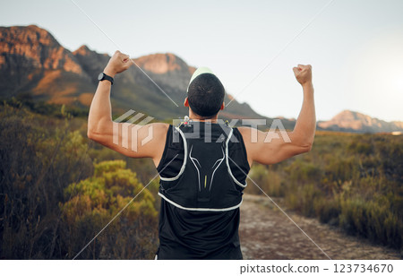 Winner, mountain and runner man success with back view celebrating cardio exercise goal victory. Muscular, strong and fitness lifestyle male running achievement celebration in South African bush. 123734670