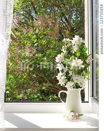 Bouquet with spring apple blossoms in a vase on a sunny window, abstract floral arrangement, still life with flowering tree branches, home interior with decor elements, floral birthday card, wedding Bouquet with spring apple blossoms in a vase on a sunny window, abstract floral arrangement, still life with flowering tree branches, home interior with decor elements, floral birthday card, wedding 123735858