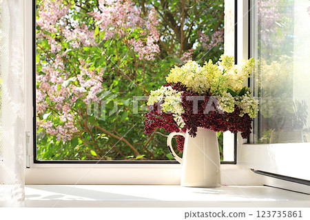 Bouquet with spring lilac flowers in a vase on a sunny window, abstract floral arrangement, still life with flowering tree branches, home interior with decor elements, floral birthday card, wedding, Bouquet with spring lilac flowers in a vase on a sunny window, abstract floral arrangement, still life with flowering tree branches, home interior with decor elements, floral birthday card, wedding, 123735861