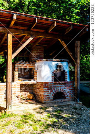 outdoor kitchen with pizza oven and barbeque grill. 123736228