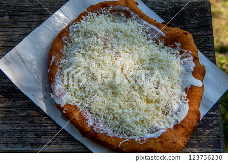 sour cream langos, streetfood. Typical homemade Hungarian food called Langos sour cream langos, streetfood. Typical homemade Hungarian food called Langos 123736230