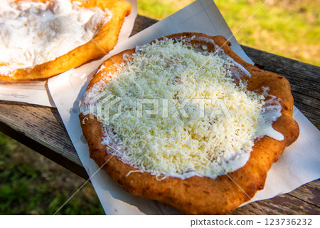 sour cream langos, streetfood. Typical homemade Hungarian food called Langos sour cream langos, streetfood. Typical homemade Hungarian food called Langos 123736232