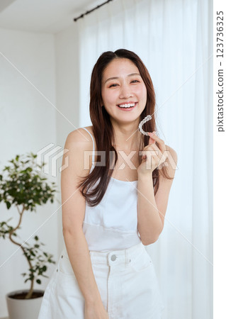 Woman with mouthpiece orthodontics 123736325