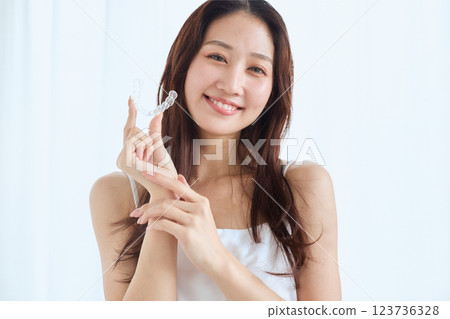 Woman with mouthpiece orthodontics 123736328