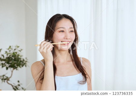 woman brushing teeth woman brushing teeth 123736335