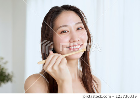 woman brushing teeth 123736339