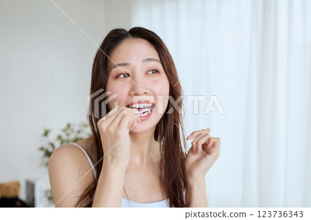 Woman doing dental floss 123736343