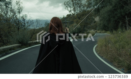 Religious Woman Walks In Street Esoteric Procession With Jesus Crucifix In Hand 123736389