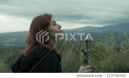 Woman Walks Among Trees With Crucifix Of Jesus In Hand Praying Christianity 123736392