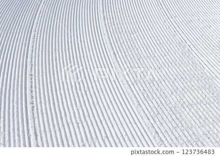 Snow groomer marks on the snow surface of a ski resort slope 123736483