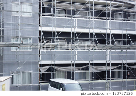 Apartment building repair work scaffolding Apartment building repair work scaffolding 123737126