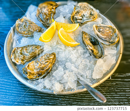 Fresh oysters on ice with lemon and white wine 123737715