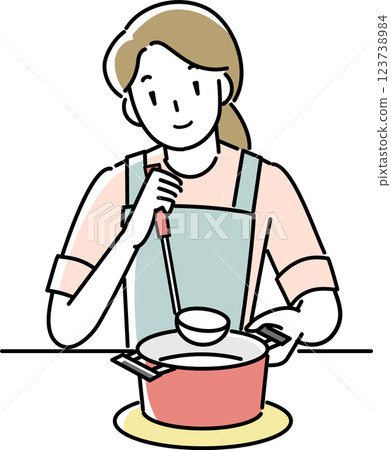 A woman wearing an apron cooking A woman wearing an apron cooking 123738984