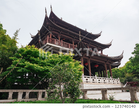 Traditional Chinese architecture showcases intricate design at a scenic outdoor location 123740140