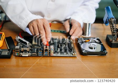 The technician repairing the motherboard in the lab with copy space. the concept of computer hardware, The technician repairing the motherboard in the lab with copy space. the concept of computer hardware, 123740420