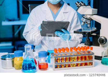 Modern medical research laboratory. female scientist hands working with micro pipettes analyzing biochemical samples Modern medical research laboratory. female scientist hands working with micro pipettes analyzing biochemical samples 123740446