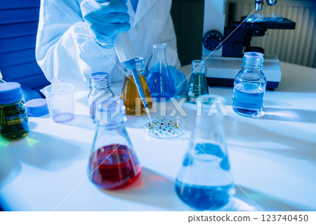 Modern medical research laboratory. female scientist hands working with micro pipettes analyzing biochemical samples Modern medical research laboratory. female scientist hands working with micro pipettes analyzing biochemical samples 123740450