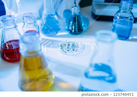Modern medical research laboratory. female scientist hands working with micro pipettes analyzing biochemical samples 123740451