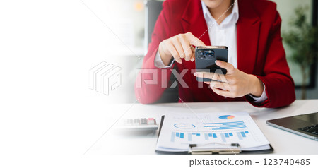 Confident businessman working on laptop,tablet and smartphone at her workplace at office Confident businessman working on laptop,tablet and smartphone at her workplace at office 123740485