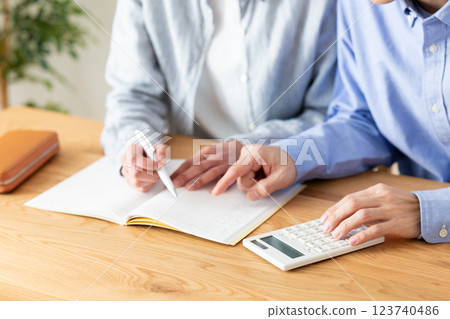 A middle-aged couple keeping a household budget at home A middle-aged couple keeping a household budget at home 123740486