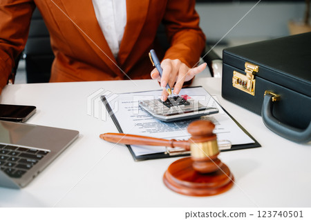 justice and law concept.businessman or lawyer or accountant working on accounts using a smart phone laptop digital tablet calculator 123740501