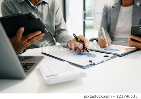 Business documents on office table with smart phone and calculator digital tablet and graph business Business documents on office table with smart phone and calculator digital tablet and graph business 123740533