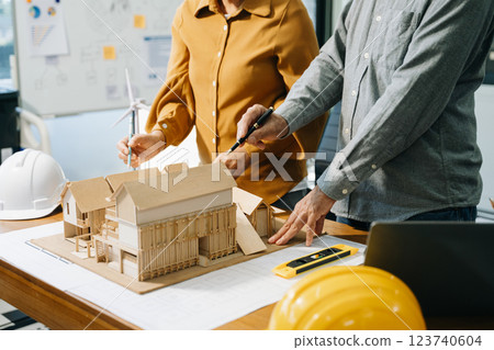 Engineer desk with object paper and tablet with blurry engineer teamwork hardworking 123740604