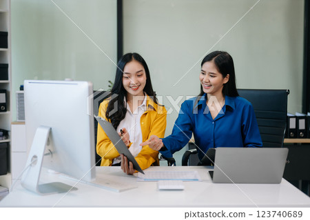 Businesswomen work and discuss their business plans. A woman employee explains Businesswomen work and discuss their business plans. A woman employee explains 123740689