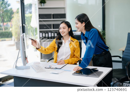 Businesswomen work and discuss their business plans. A woman employee explains Businesswomen work and discuss their business plans. A woman employee explains 123740691