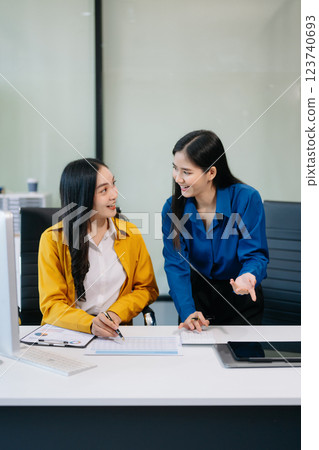 Businesswomen work and discuss their business plans. A woman employee explains Businesswomen work and discuss their business plans. A woman employee explains 123740693