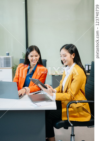 Businesswomen work and discuss their business plans. A woman employee explains Businesswomen work and discuss their business plans. A woman employee explains 123740739