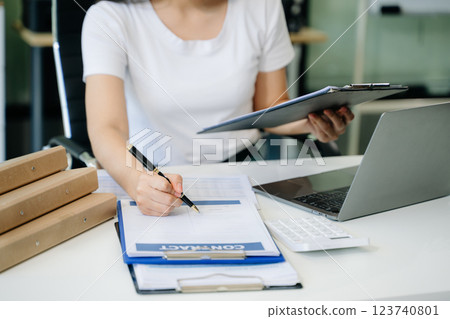 Confident businessman working on laptop, tablet and smartphone at her workplace Confident businessman working on laptop, tablet and smartphone at her workplace 123740801