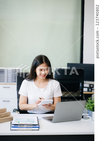 Business woman using tablet and laptop for doing math finance on an office desk, tax, Business woman using tablet and laptop for doing math finance on an office desk, tax, 123740802