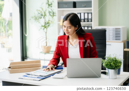 Business woman using tablet and laptop for doing math finance on an office desk, tax, 123740830