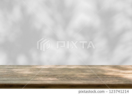 Empty wood table top on white wall texture with tree leaves shadow background 123741214