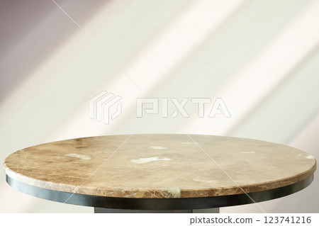 Round marble table top with abstract shadow drop on white wall background for mockup product display 123741216