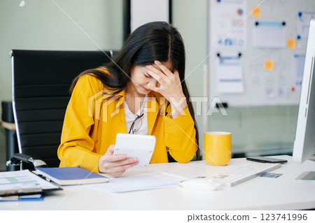 Asian business woman is stressed, bored, and overthinking from working Asian business woman is stressed, bored, and overthinking from working 123741996